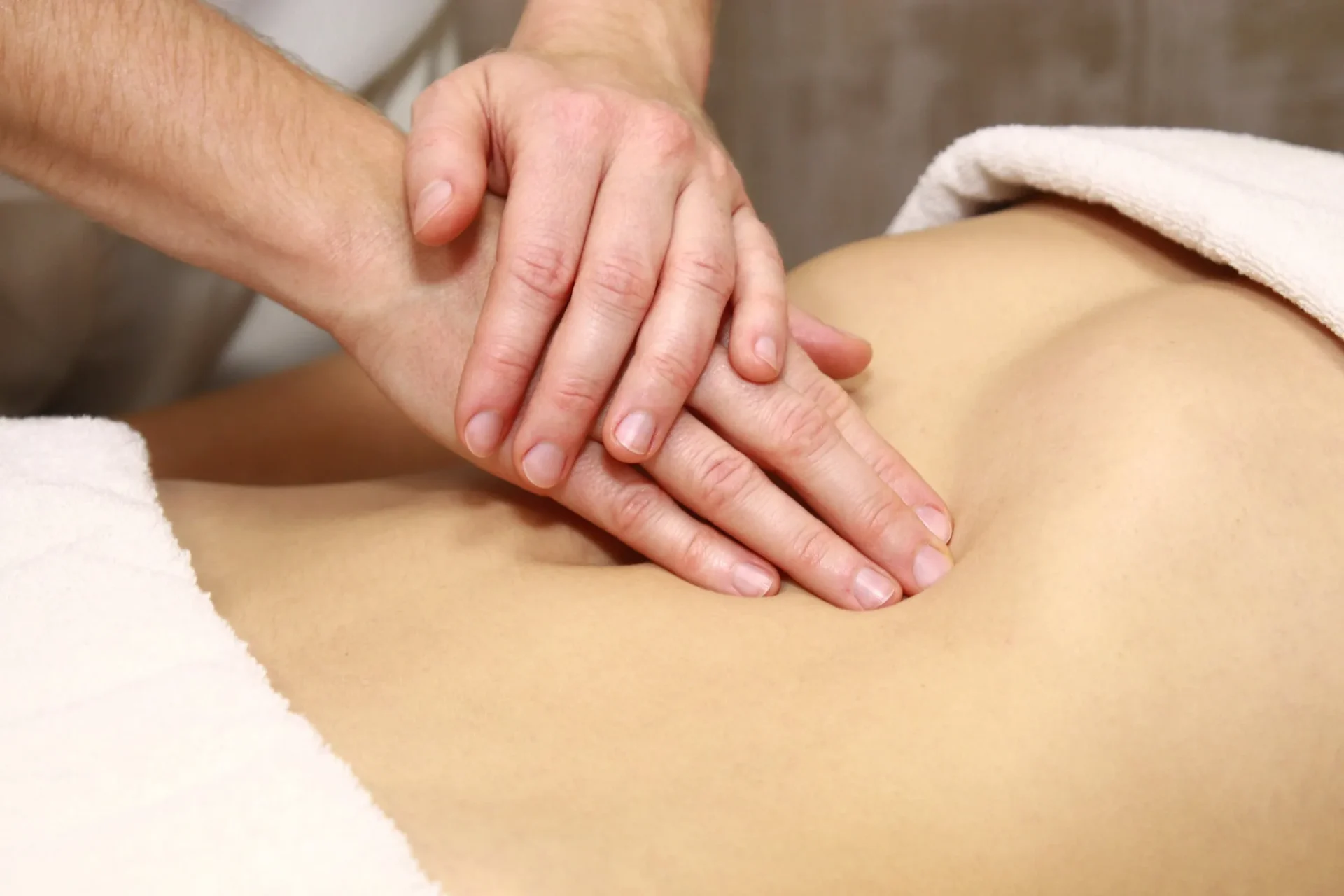 Mãos realizando massagem redutora nas costas